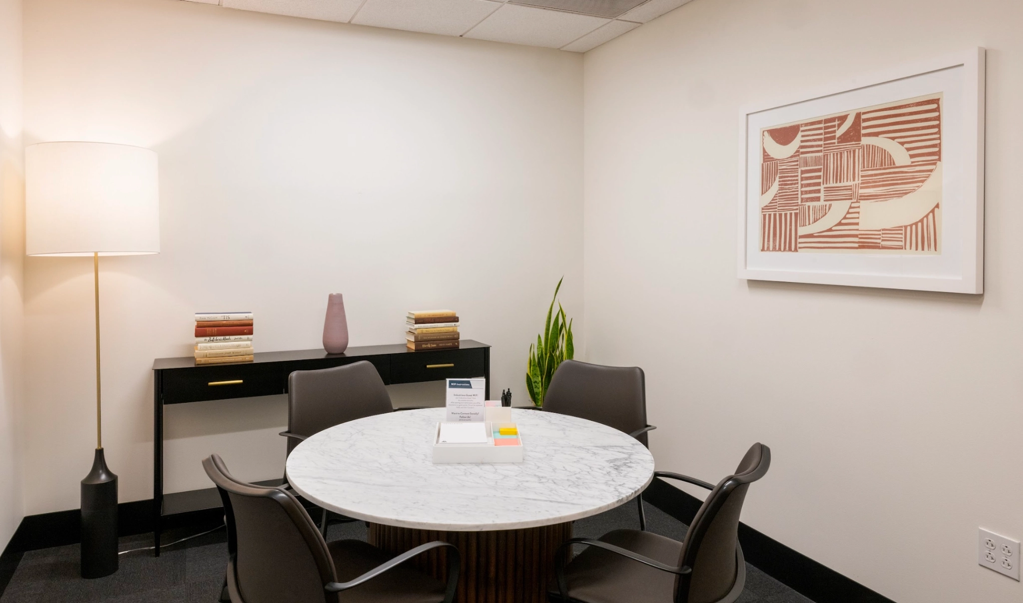 An office conference room equipped with a table and chairs for coworking and meetings.