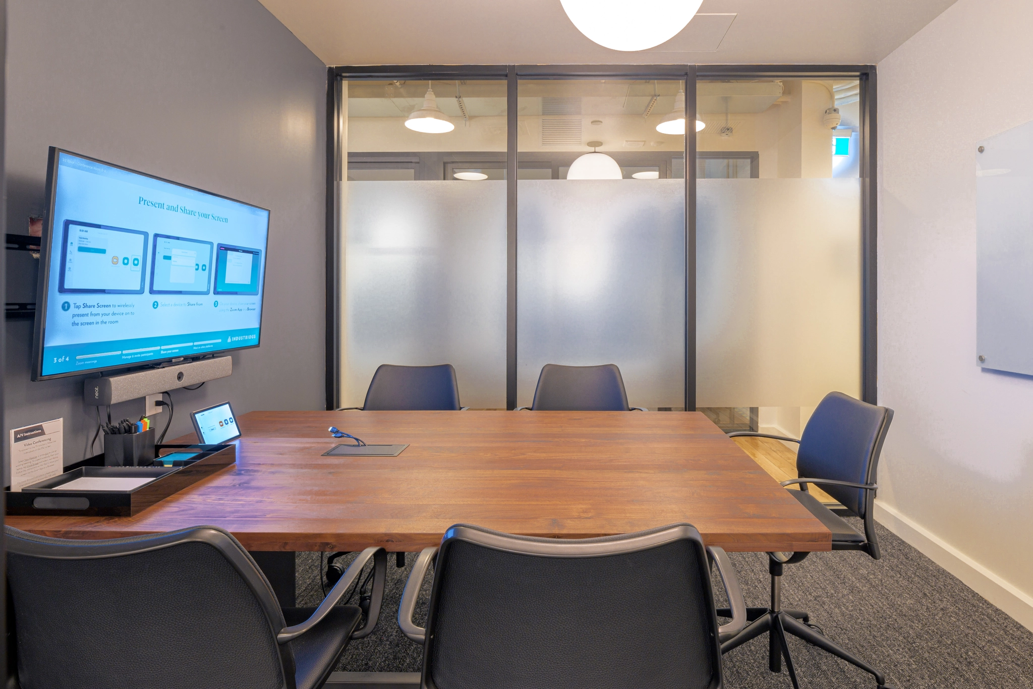a large, bright meeting room with a large screen