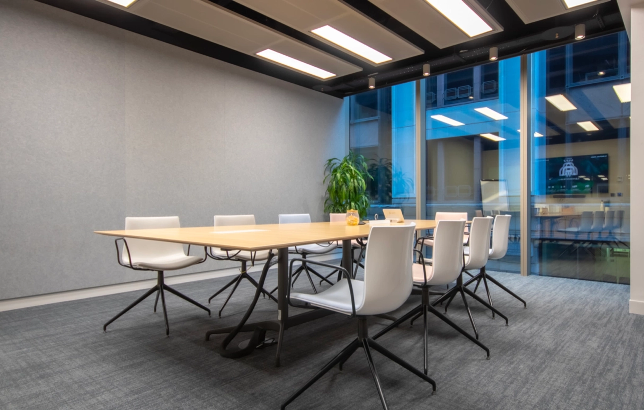 A coworking office space in London equipped with a conference room featuring a table and chairs.