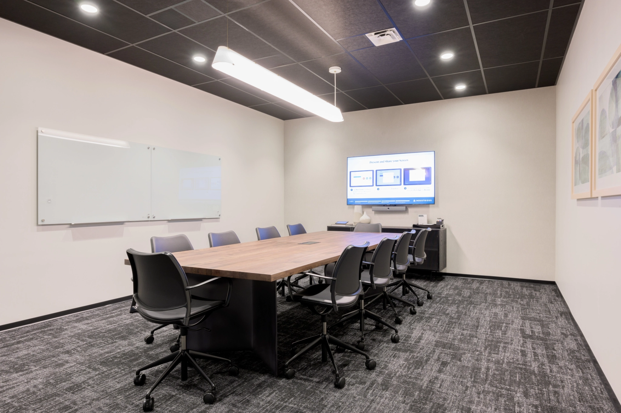 A coworking meeting room with a large table and chairs.