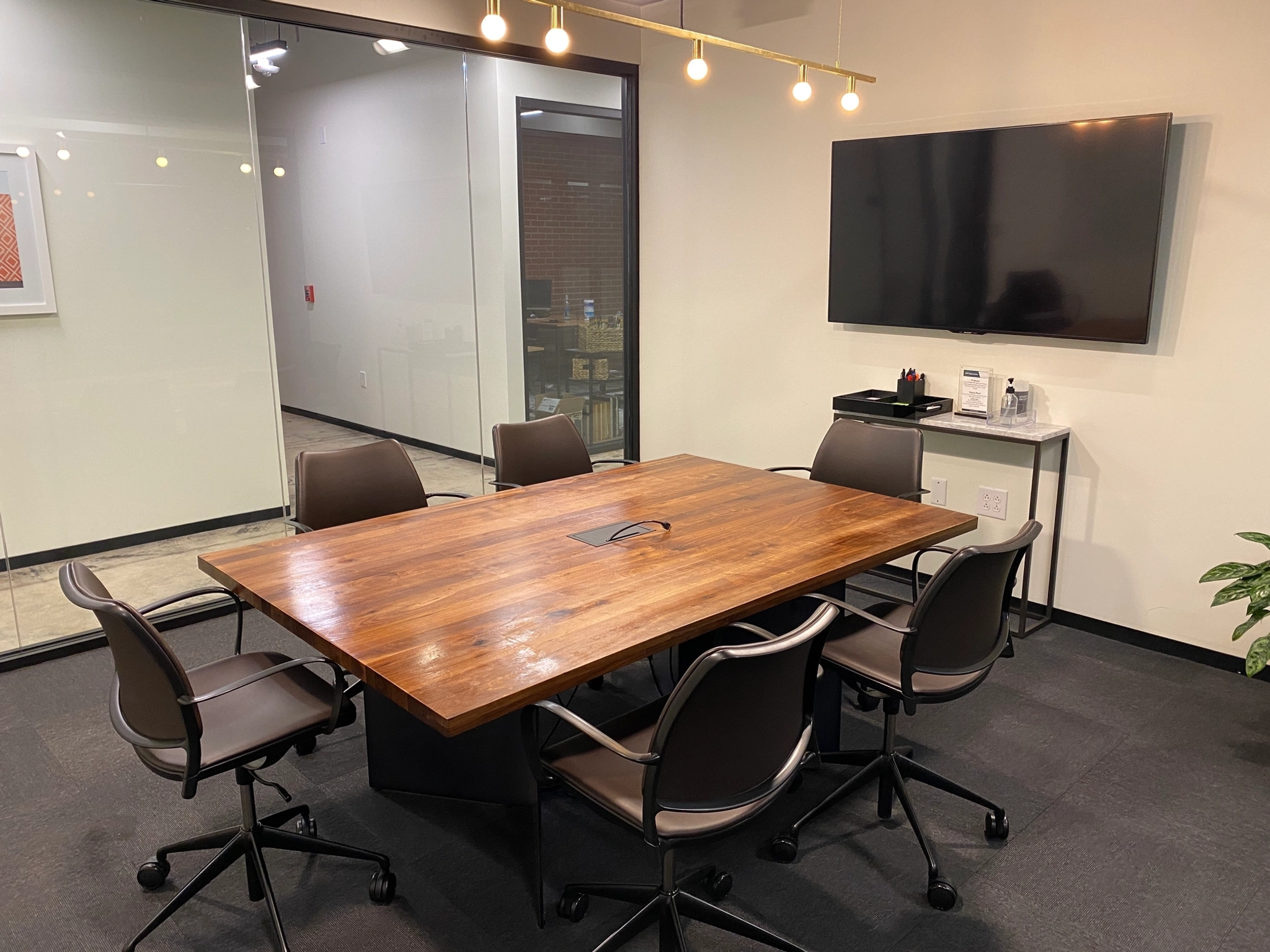 A spacious conference room in Phoenix with a sleek wooden table and comfortable chairs, providing an ideal workspace for productive meetings.