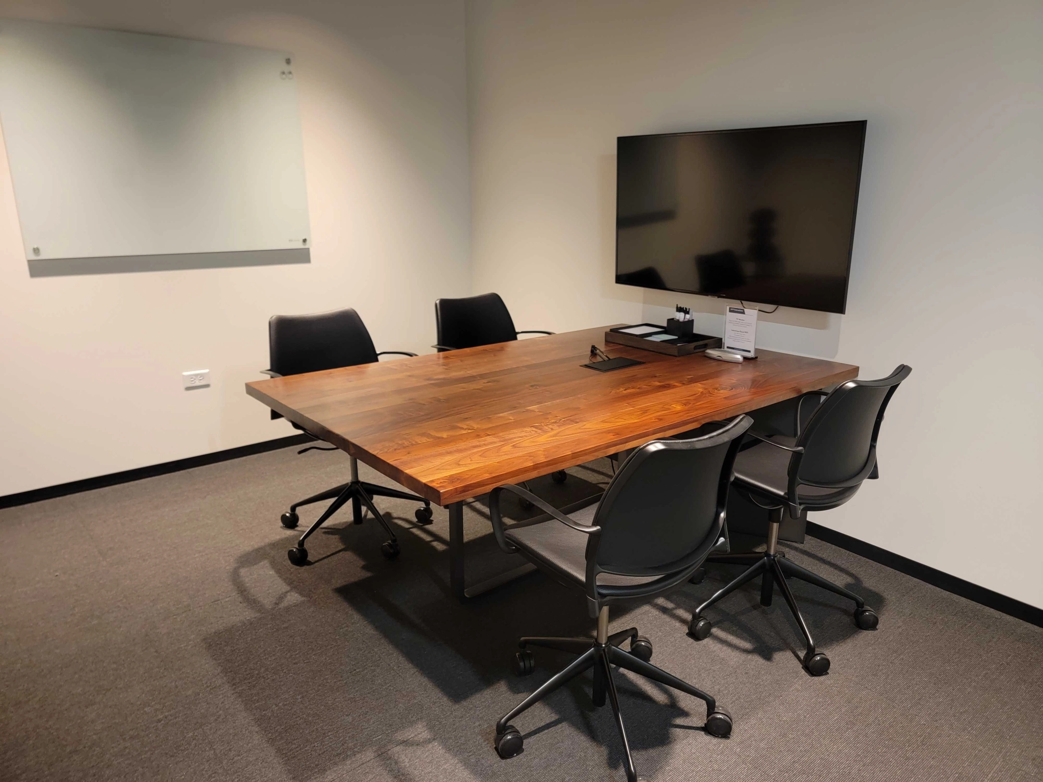 Een coworking-kantoor met een houten tafel en stoelen.