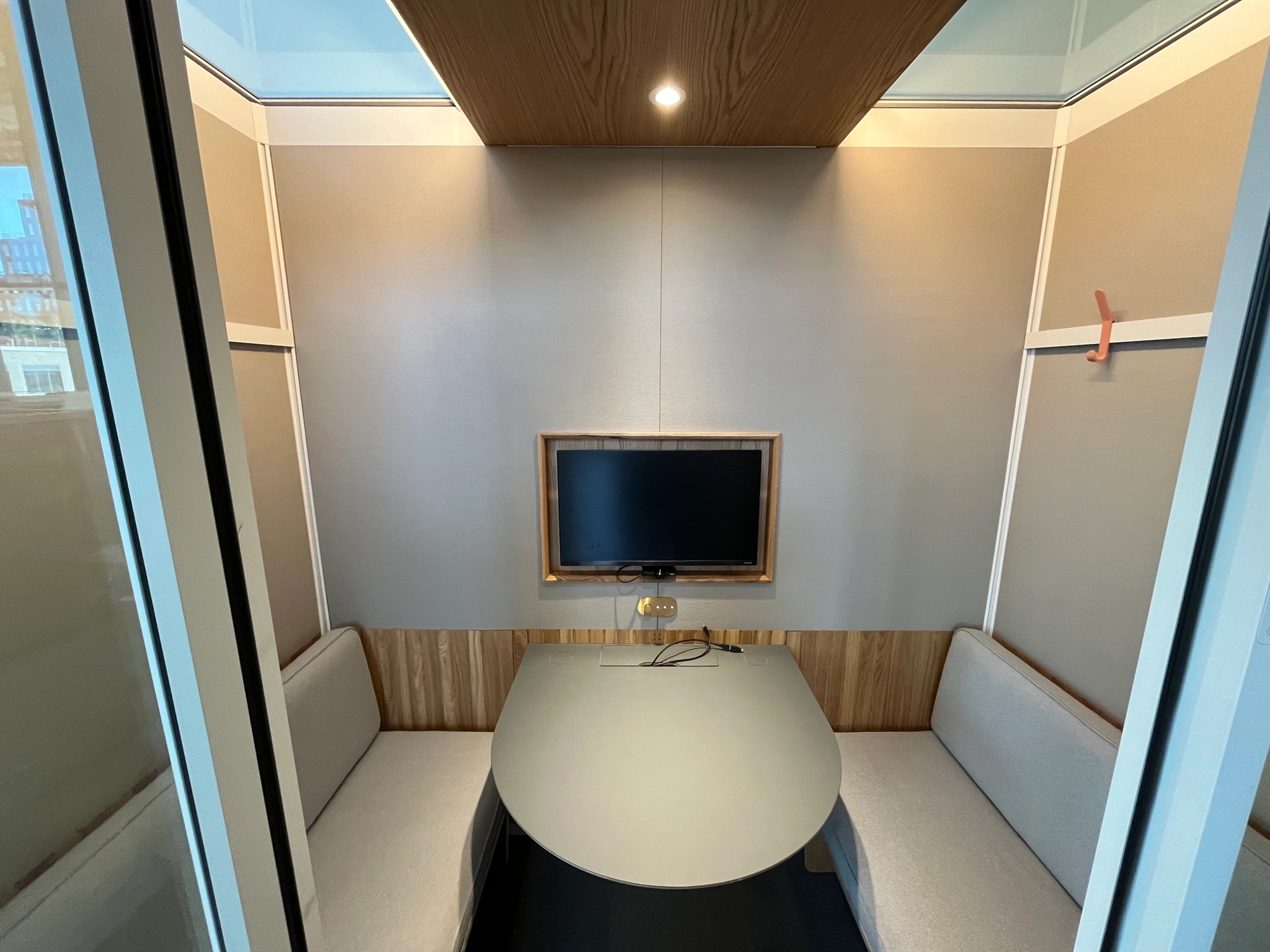 An office workspace in Atlanta with a table and chairs and a TV.