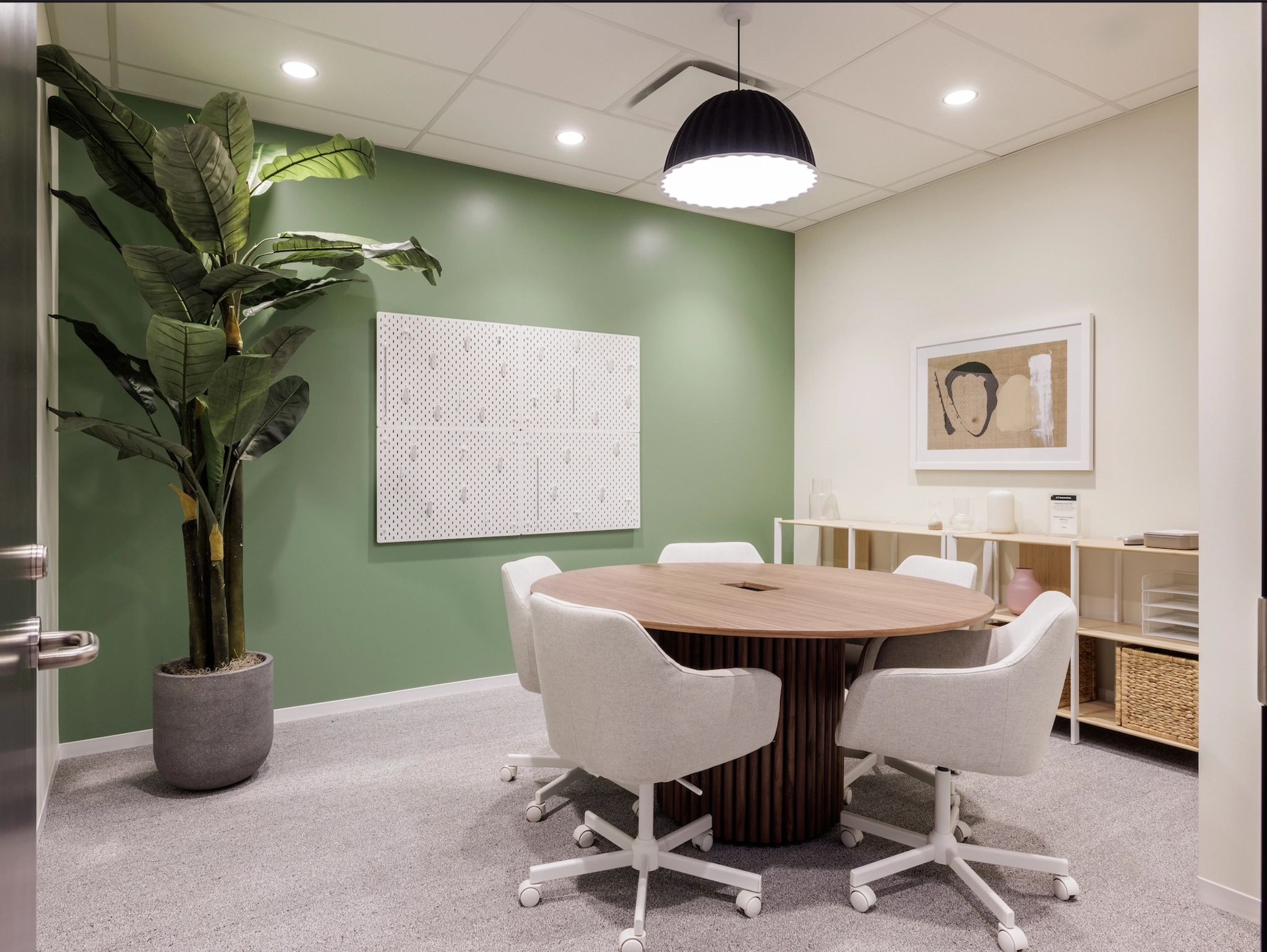 A conference room with green walls, suitable for meetings.