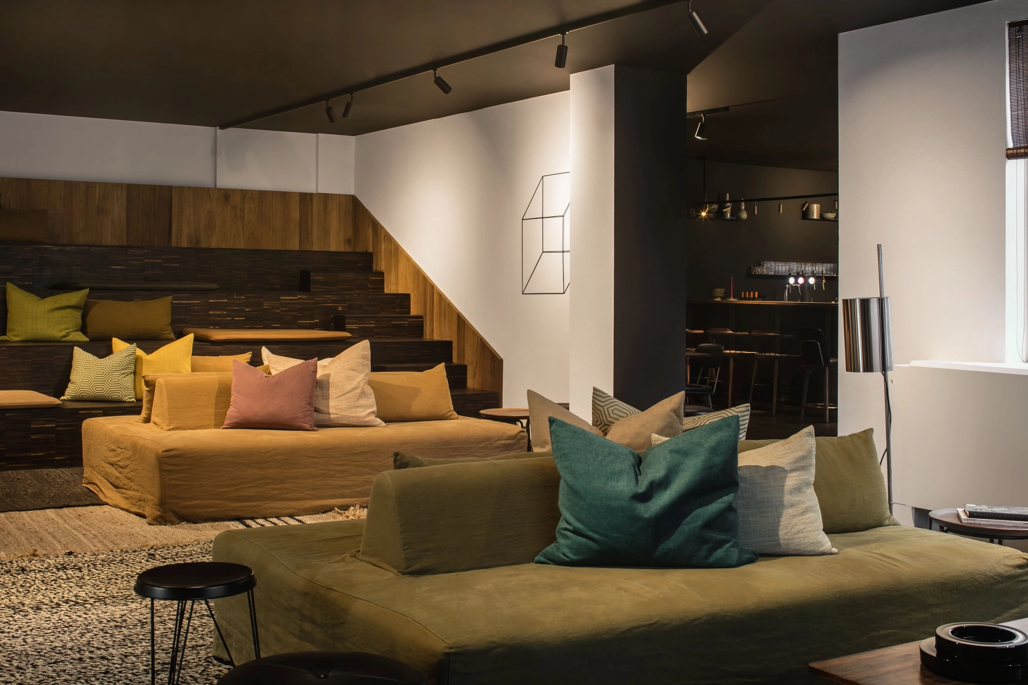 A living room with cozy couches and a coffee table perfect for creating a comfortable workspace or coworking environment.