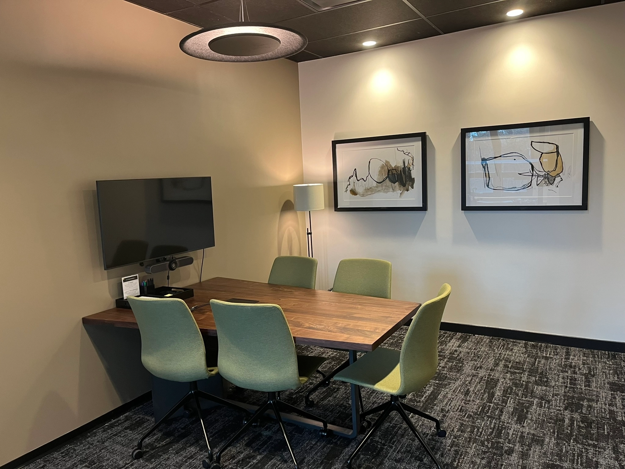 A meeting room with a table and chairs.