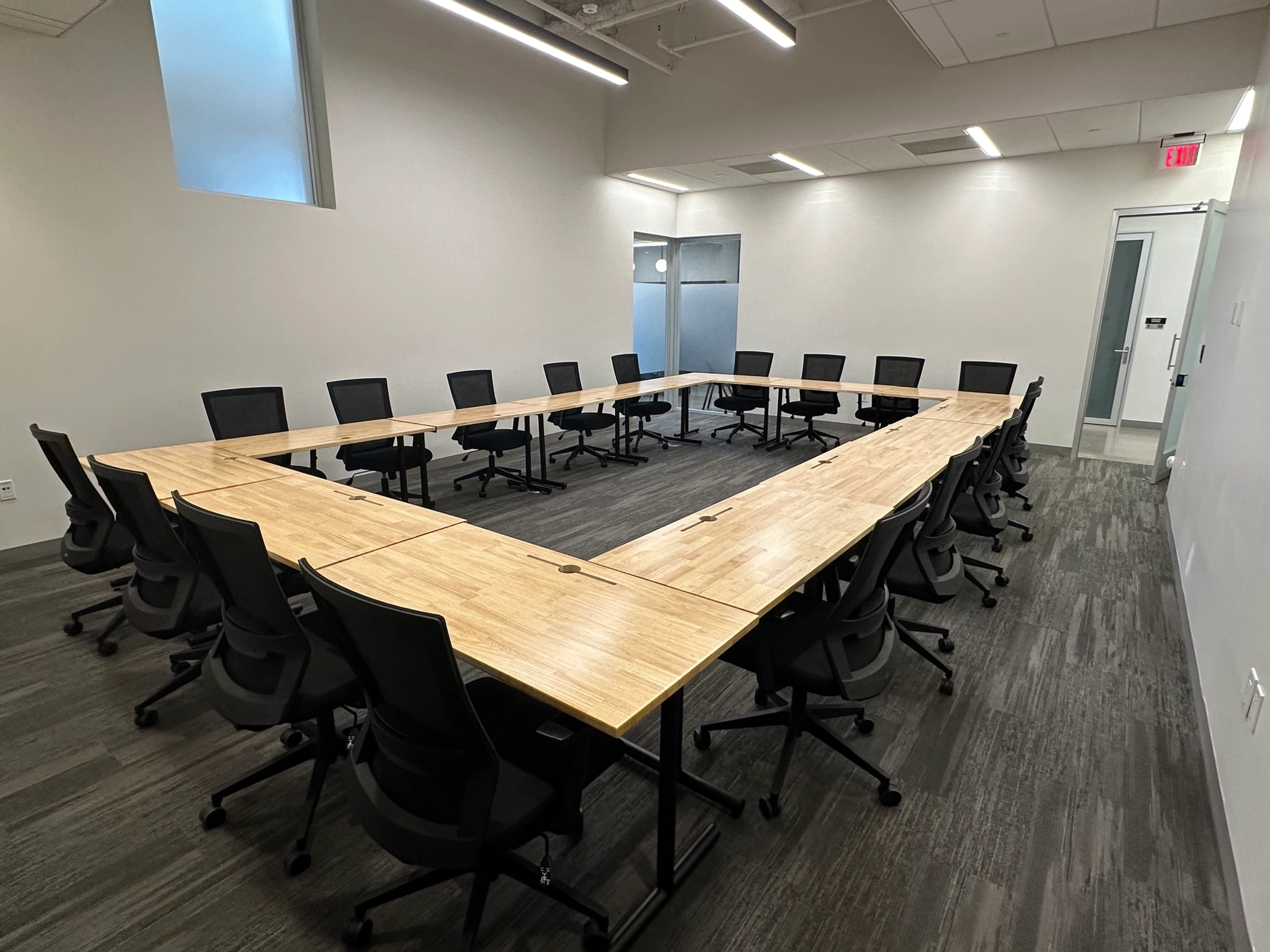 Modern meeting room in Bethesda with a large rectangular table and black chairs.