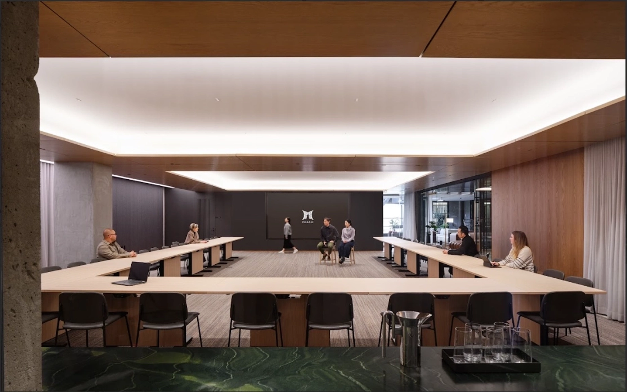 a large, bright meeting room with a large screen