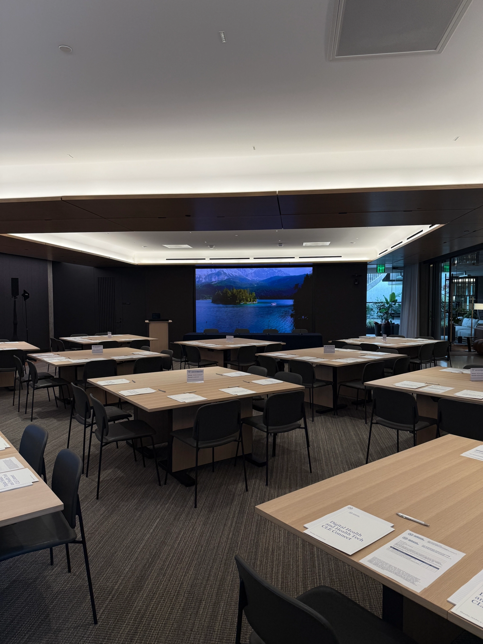 a large, bright meeting room with a large screen