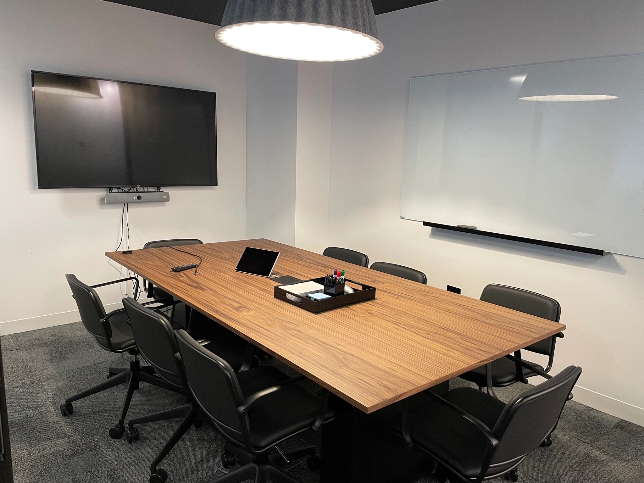 a large, bright meeting room with a large screen