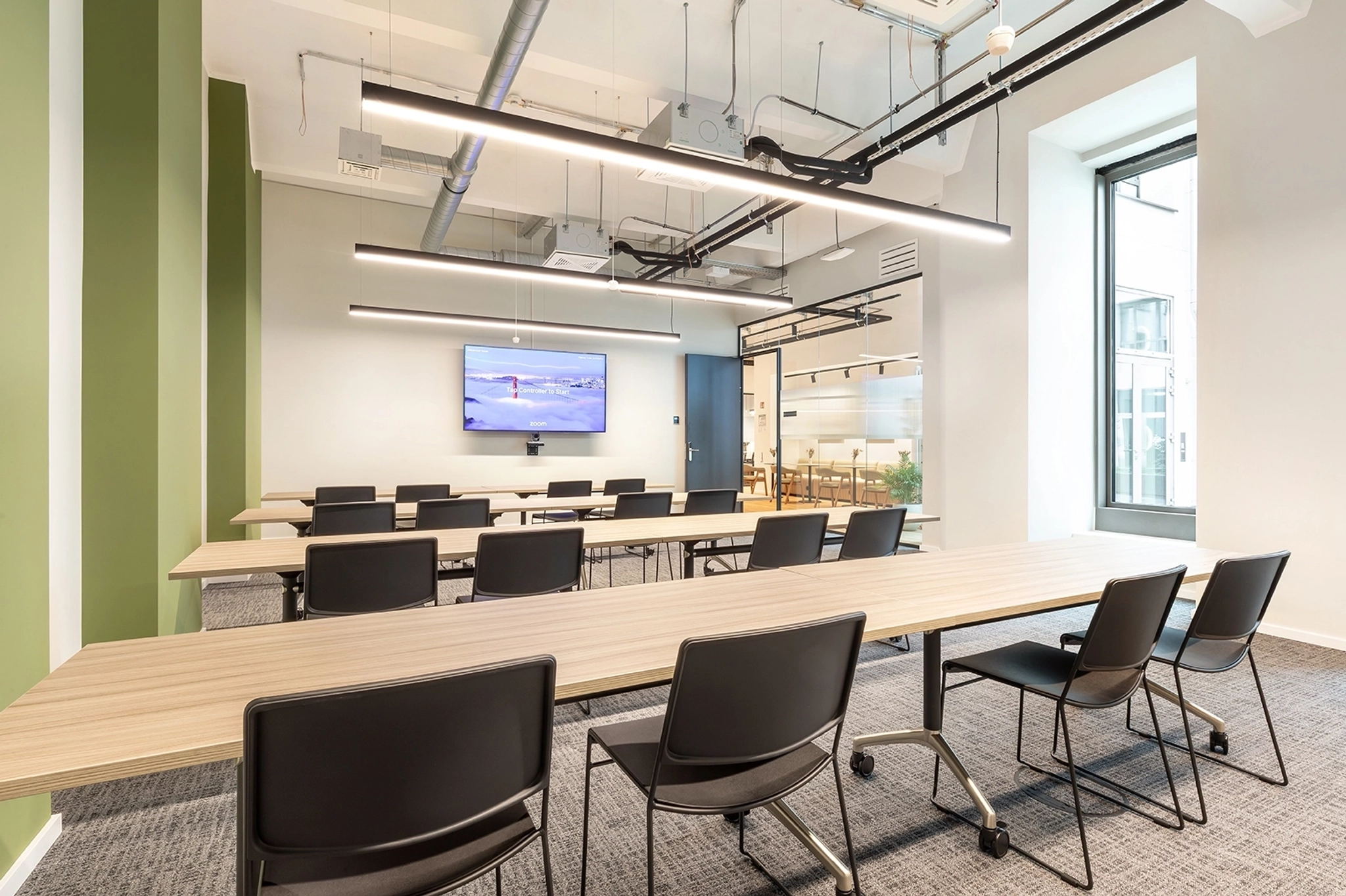 a large, bright meeting room with a large screen