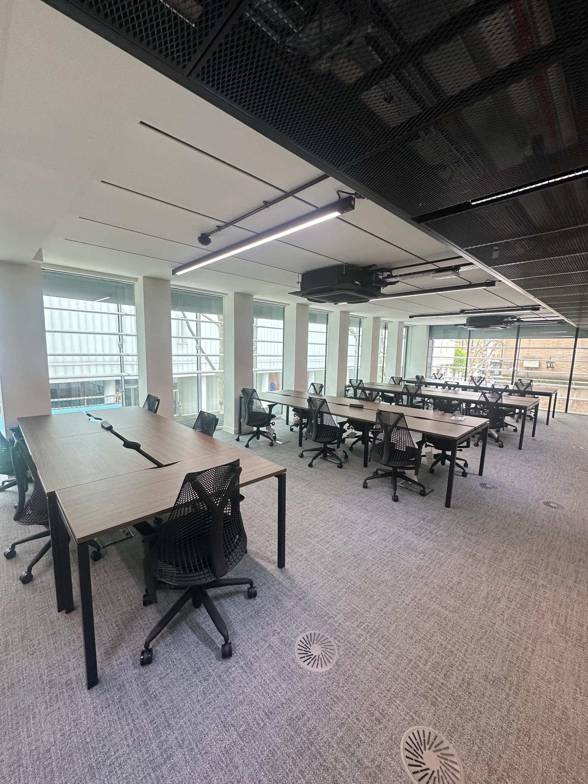a large, bright meeting room with a large screen