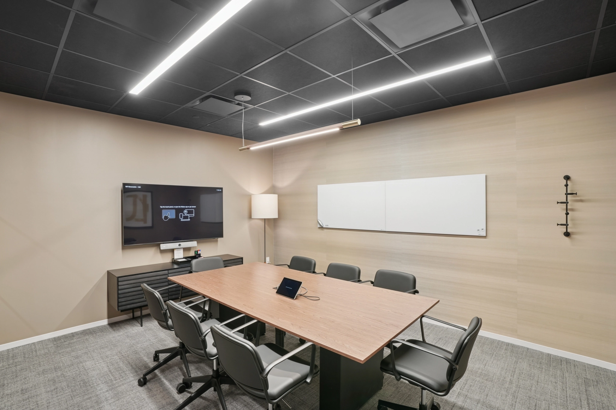 a large, bright meeting room with a large screen