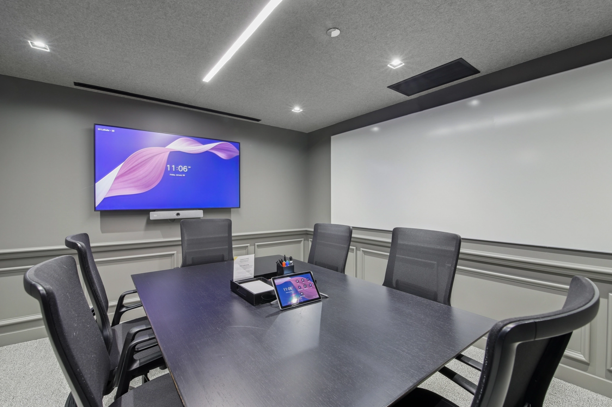 a large, bright meeting room with a large screen