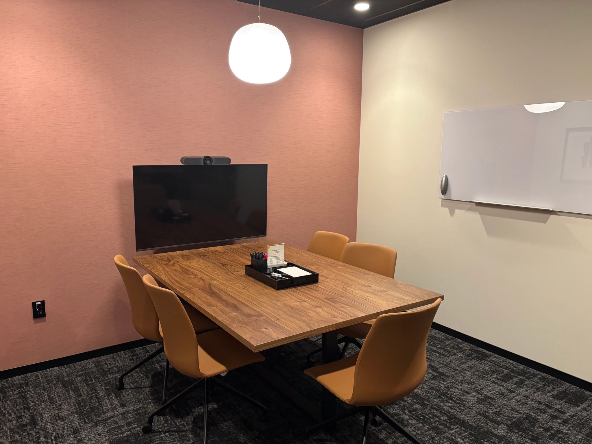 a large, bright meeting room with a large screen