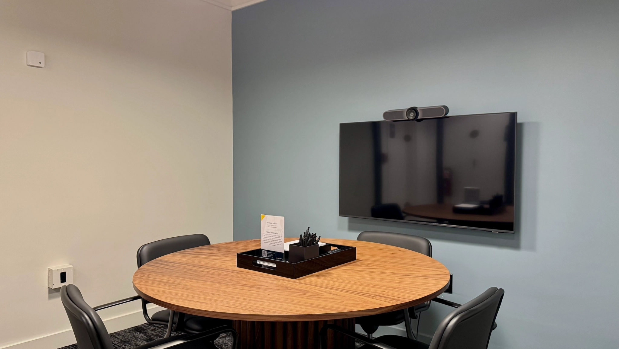 a large, bright meeting room with a large screen