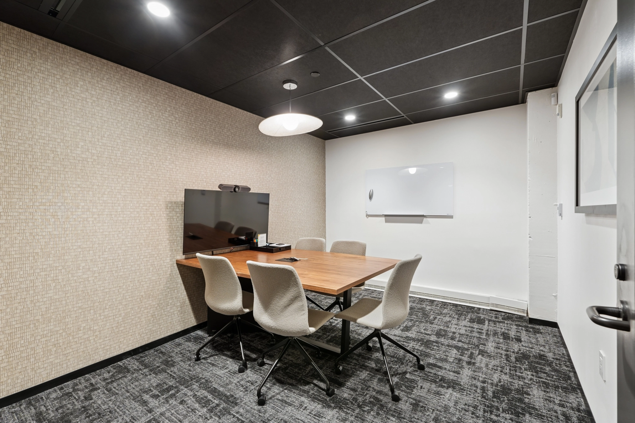 a large, bright meeting room with a large screen