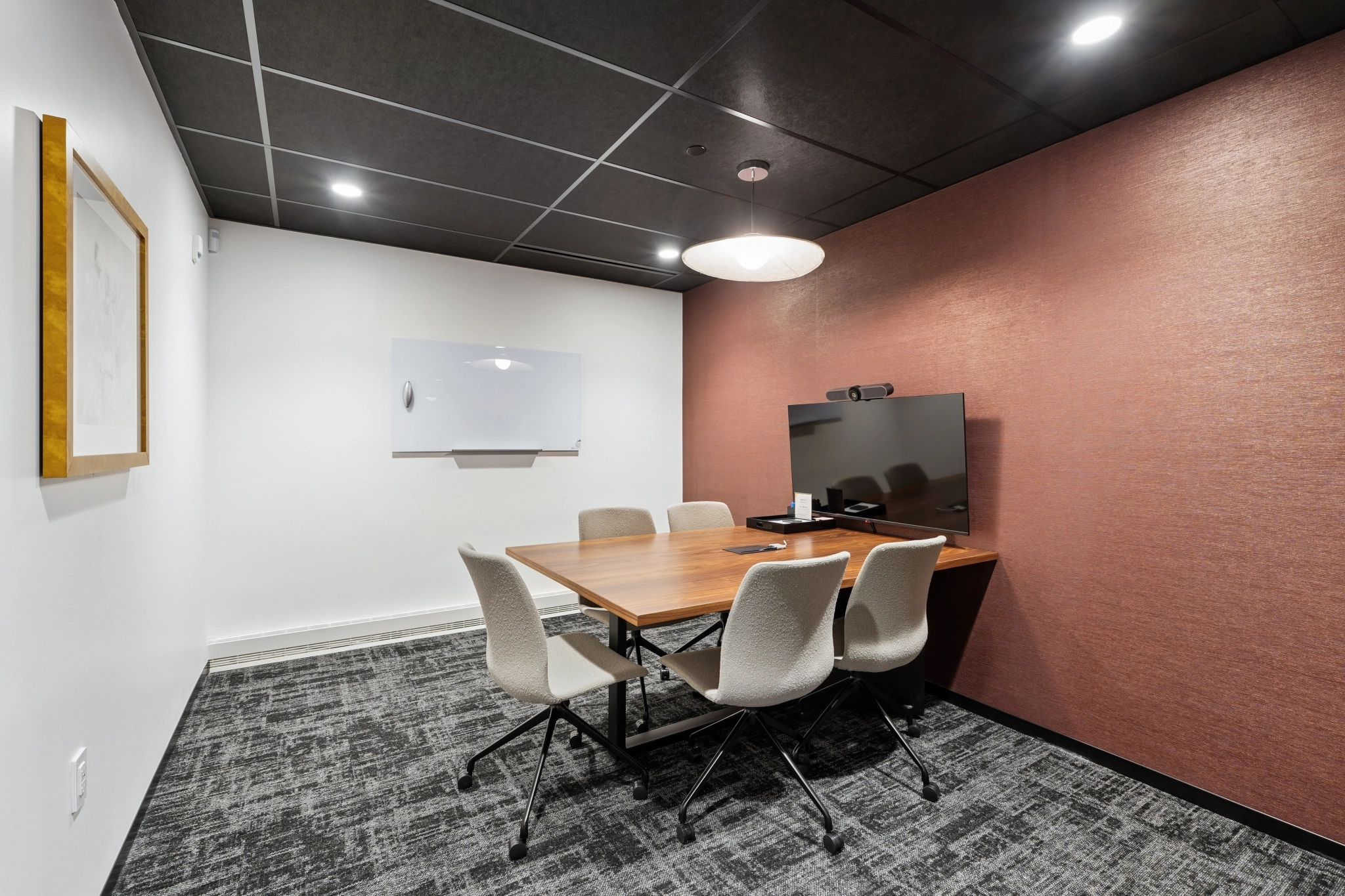 a large, bright meeting room with a large screen