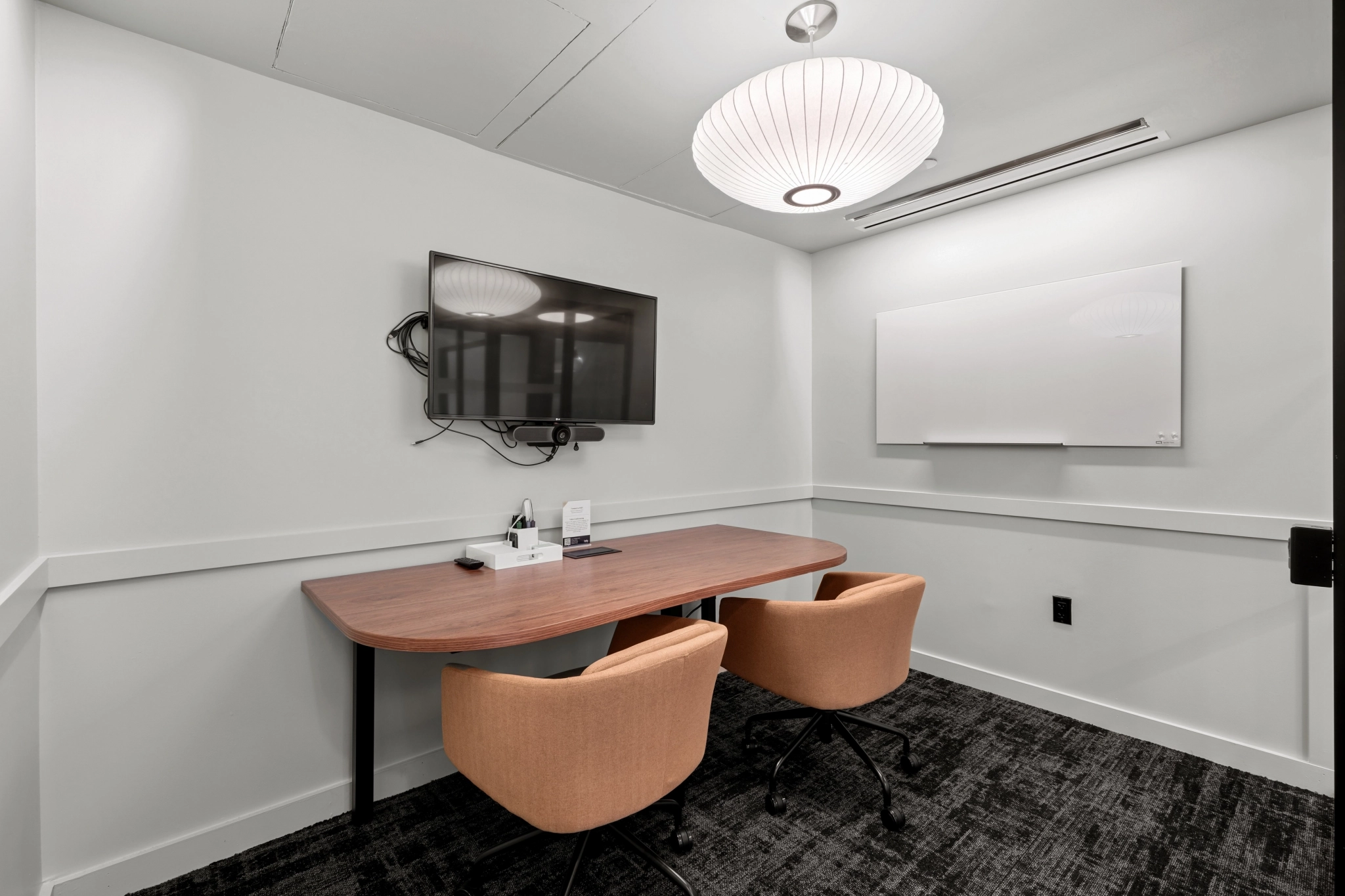 a large, bright meeting room with a large screen