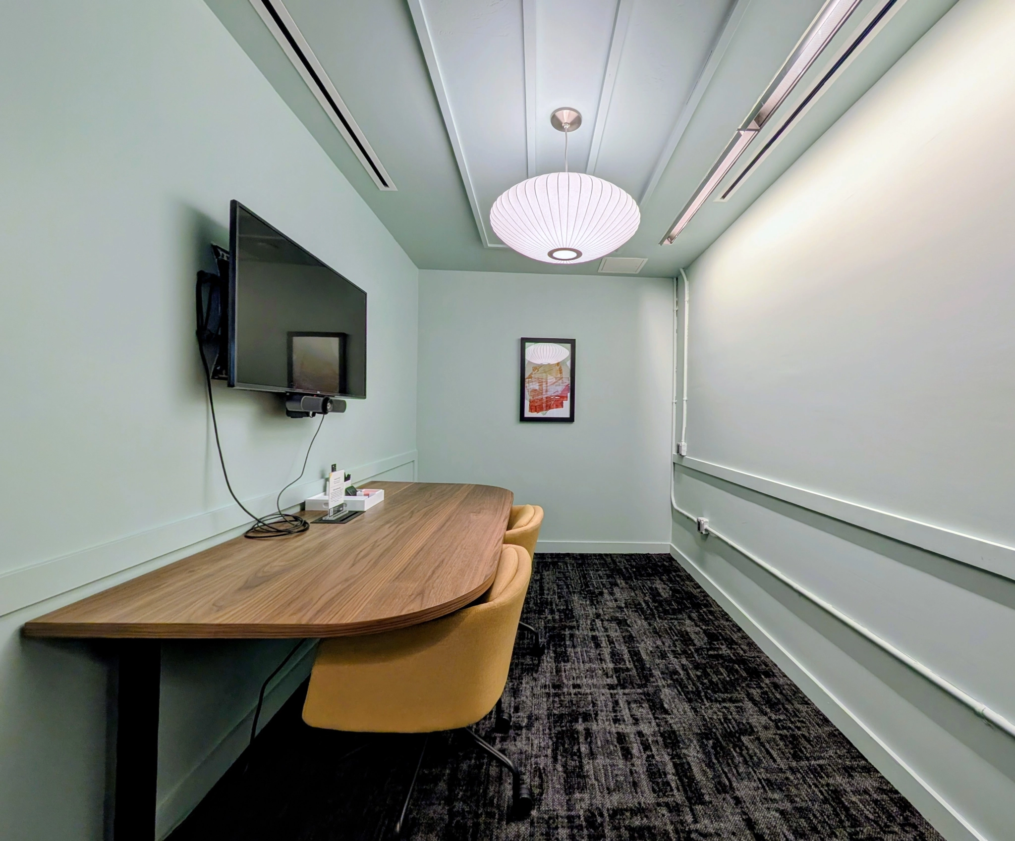 a large, bright meeting room with a large screen